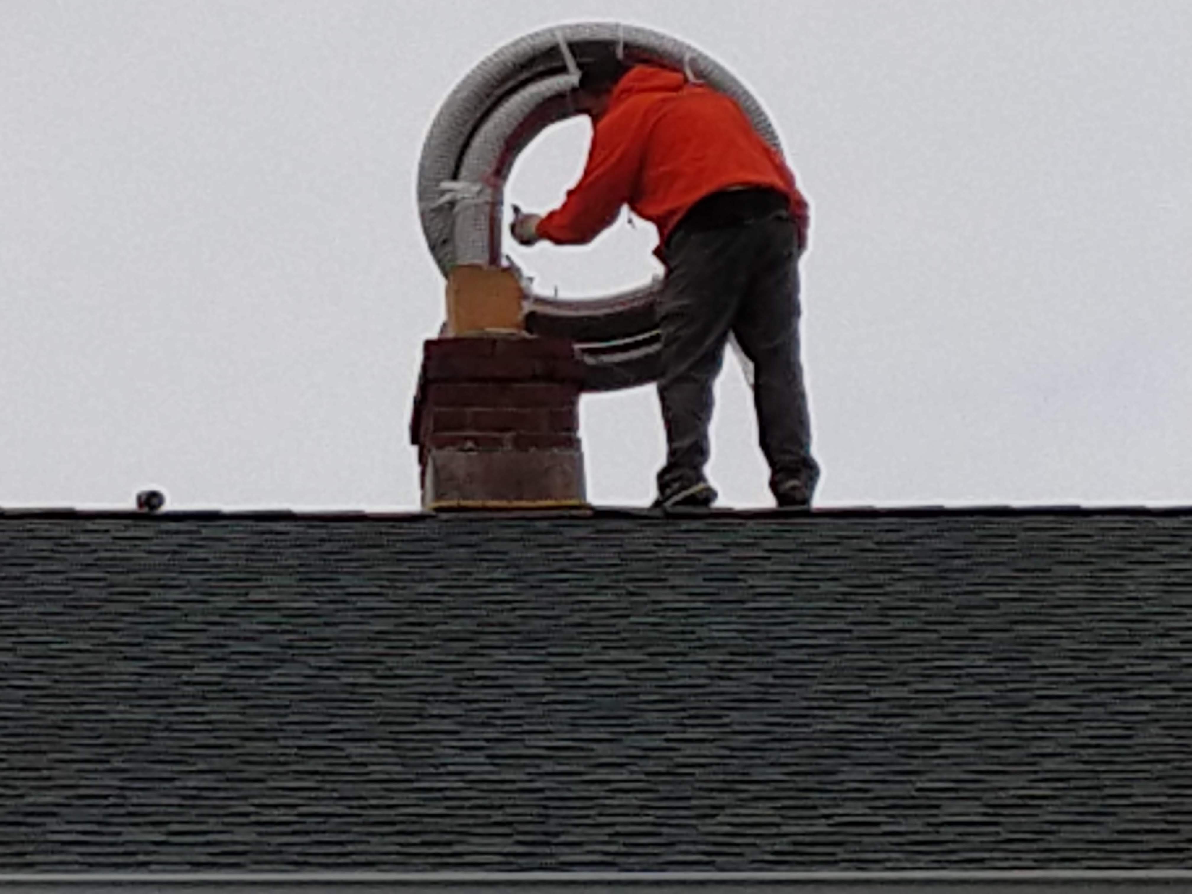 Flexible stainless chimney liner being installed in Southampton, New York